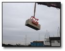 The blocks are lifted via a 360 excavator ready for positioning